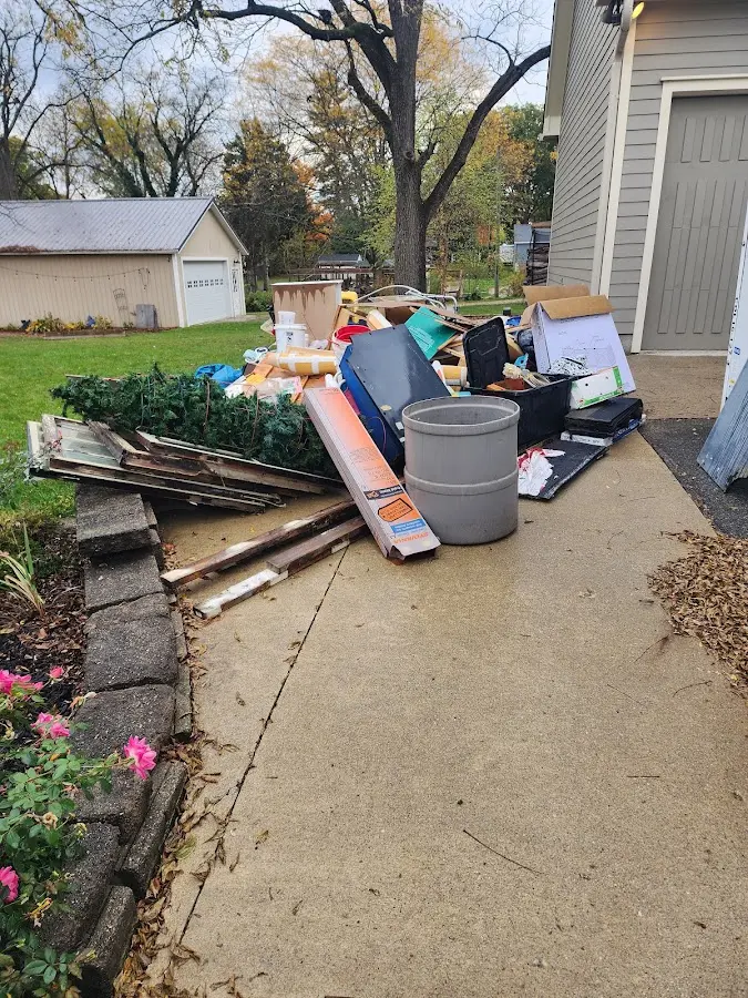 Dumpster being loaded with debris for 3 Yard Dumpster Rental in Maplewood